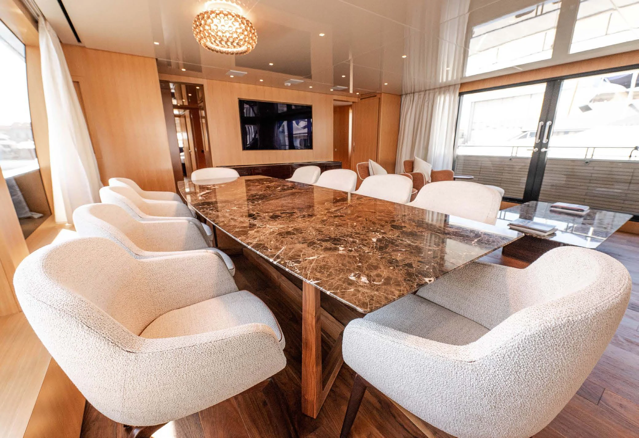 a large room with a table and chairs aboard VISSOTTA Yacht for Sale