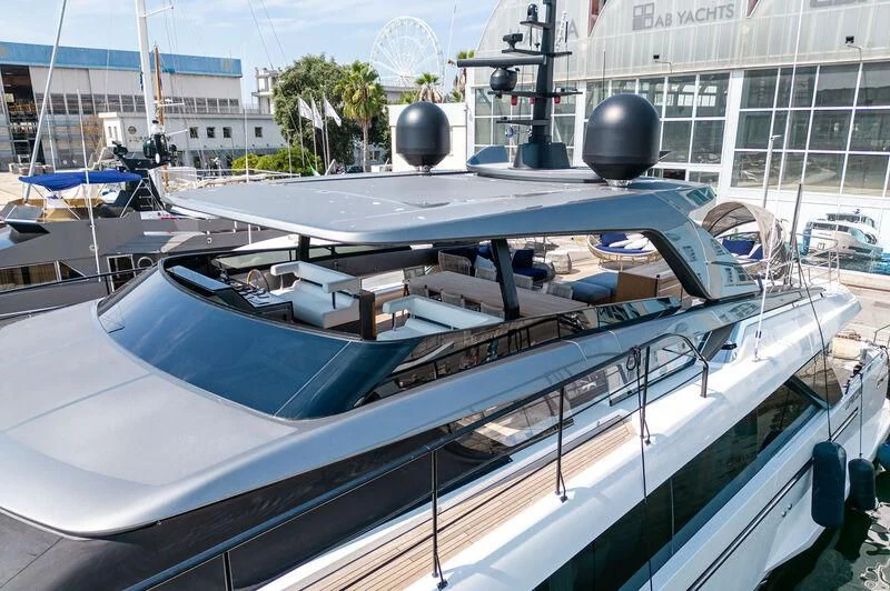 a large white boat with a blue canopy aboard VISSOTTA Yacht for Sale