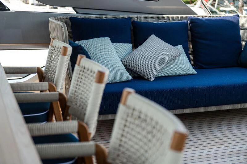 a blue couch with blue pillows aboard VISSOTTA Yacht for Sale