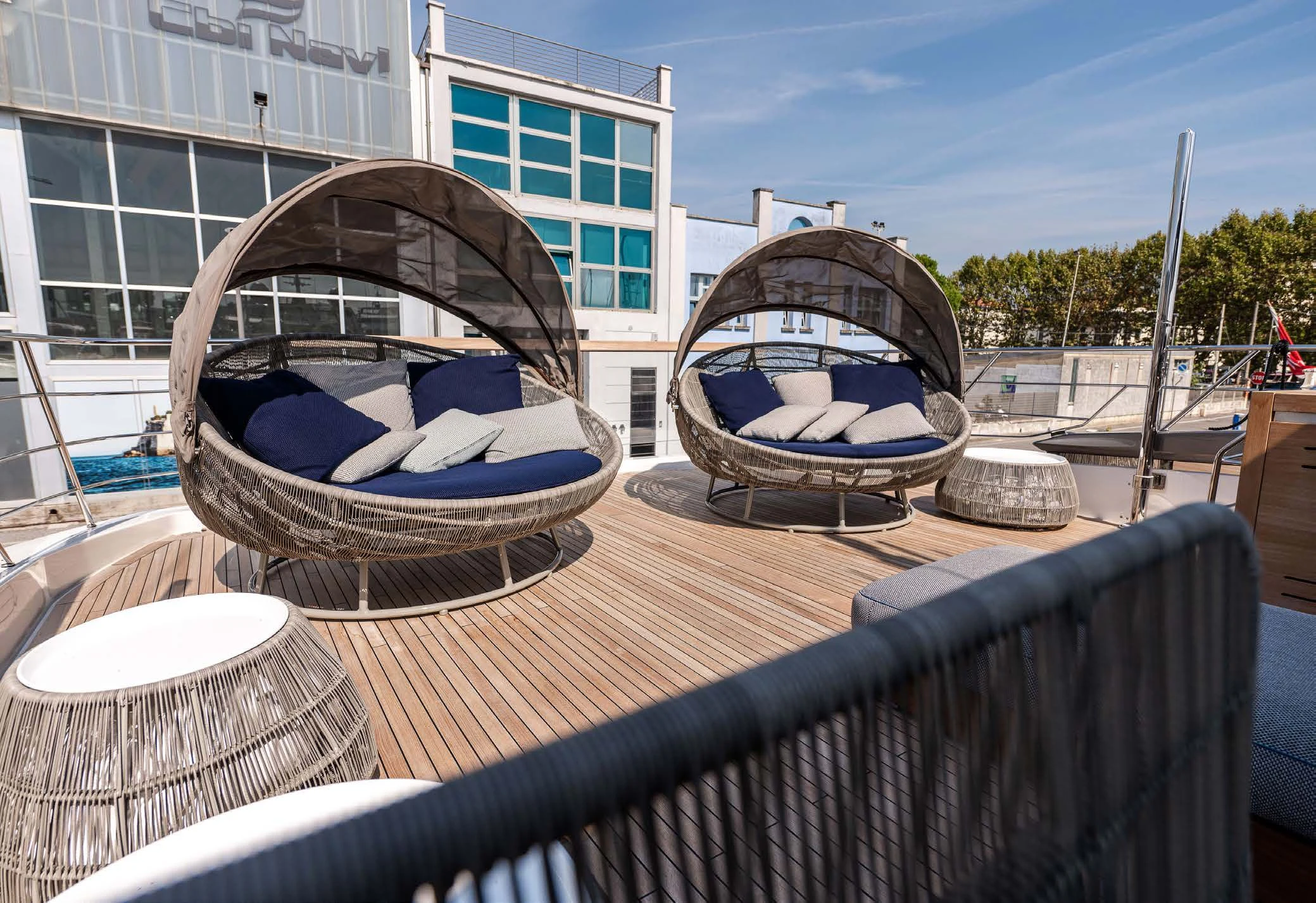 a round metal object on a wood surface with a building in the background aboard VISSOTTA Yacht for Sale