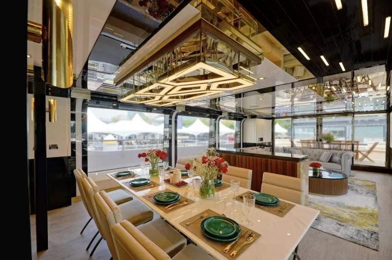 a dining room with a table and chairs aboard BOKE 125 Yacht for Sale