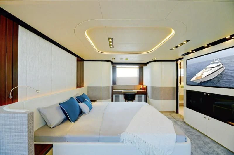 a room with a bed and a table aboard BOKE 125 Yacht for Sale