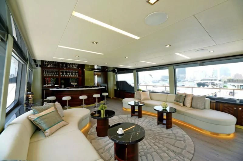 a living room with a large window aboard BOKE 125 Yacht for Sale