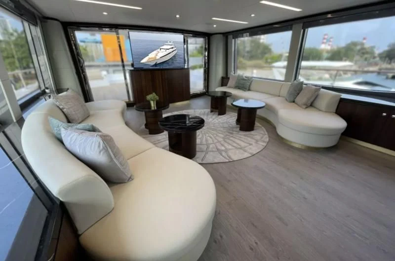 a living room with couches and a tv aboard BOKE 125 Yacht for Sale