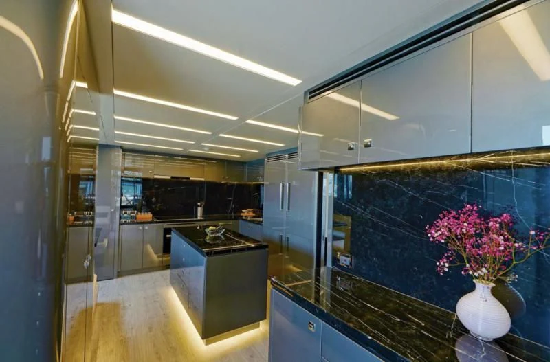 a room with a glass wall and a vase with flowers in it aboard BOKE 125 Yacht for Sale