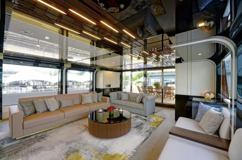 a living room with a large window aboard BOKE 125 Yacht for Sale