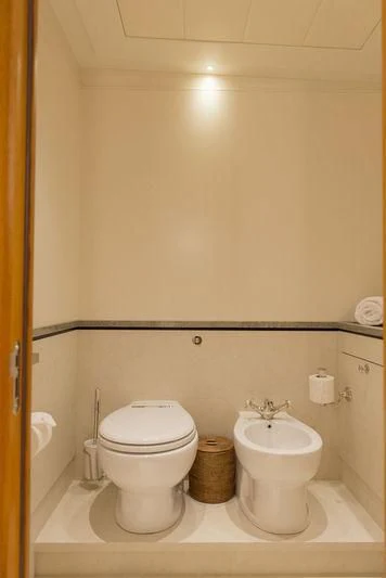 a bathroom with a toilet sink and a mirror aboard WISP Yacht for Sale