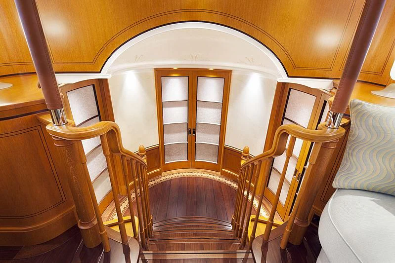 a room with wooden stairs aboard WISP Yacht for Sale