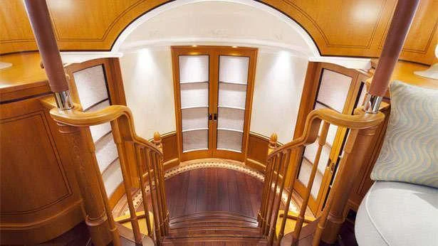 a room with wooden furniture aboard WISP Yacht for Sale