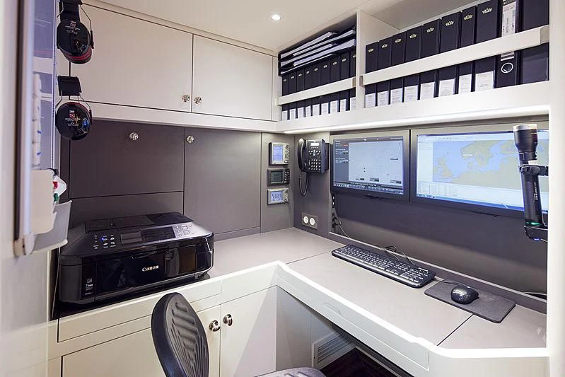 a room with computers and monitors aboard WISP Yacht for Sale