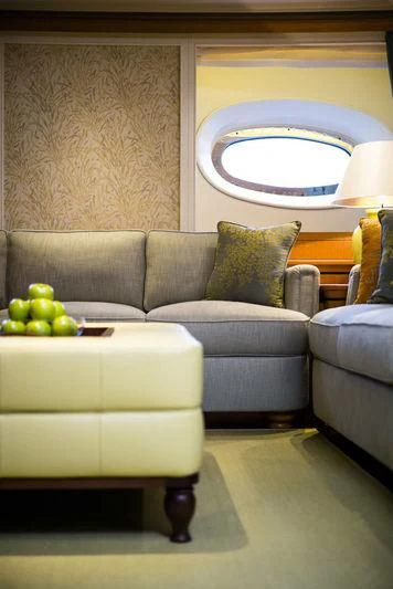 a couch and a window in a room aboard WISP Yacht for Sale