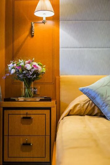 a dresser with a vase of flowers on it aboard WISP Yacht for Sale