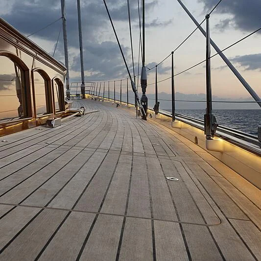a wooden dock with a boat on it and a person on it aboard WISP Yacht for Sale