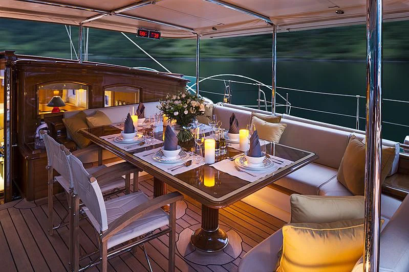 a table set with candles and flowers aboard WISP Yacht for Sale