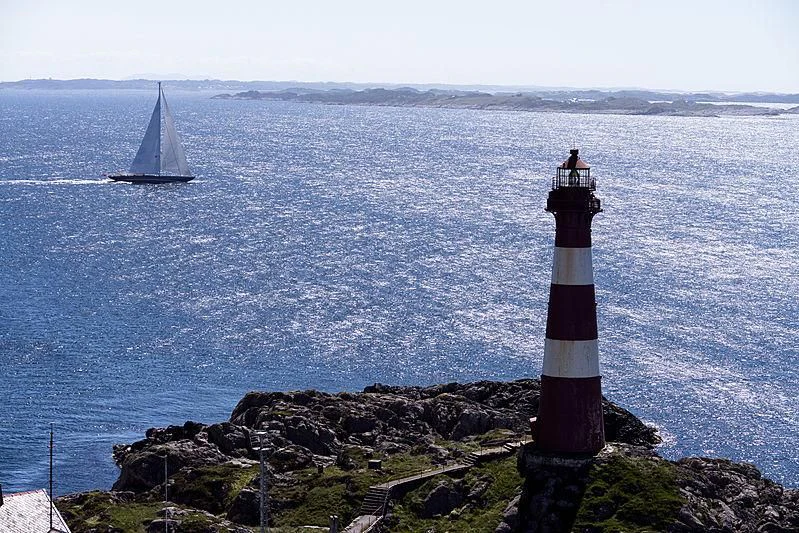a lighthouse on a rocky shore aboard WISP Yacht for Sale