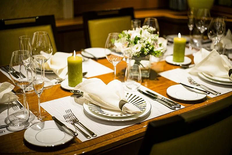 a table with plates and glasses aboard WISP Yacht for Sale