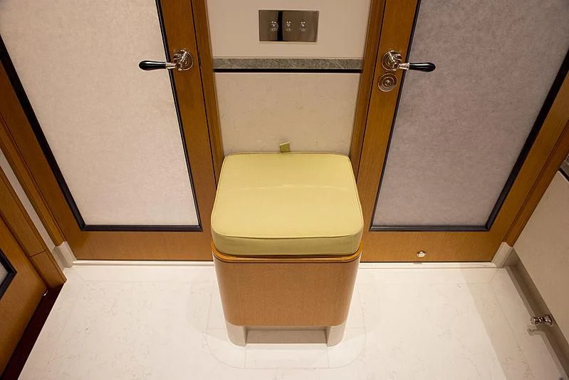 a yellow toilet in a bathroom aboard WISP Yacht for Sale