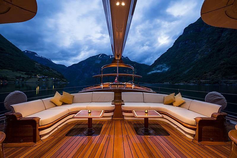 a large living room with a large window overlooking a large mountain range aboard WISP Yacht for Sale