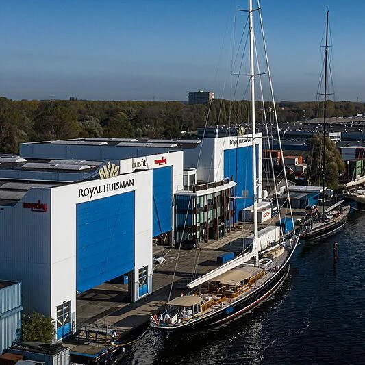 a large boat docked at a pier aboard WISP Yacht for Sale