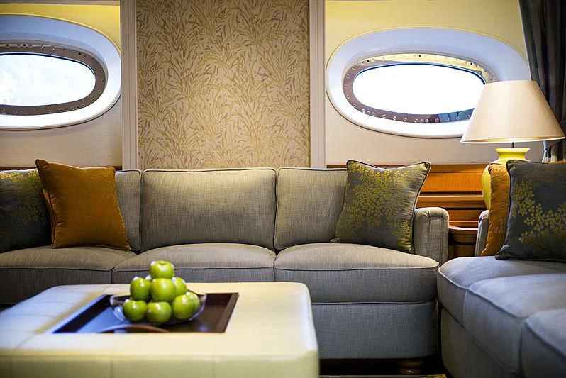 a couch with a table and a window aboard WISP Yacht for Sale