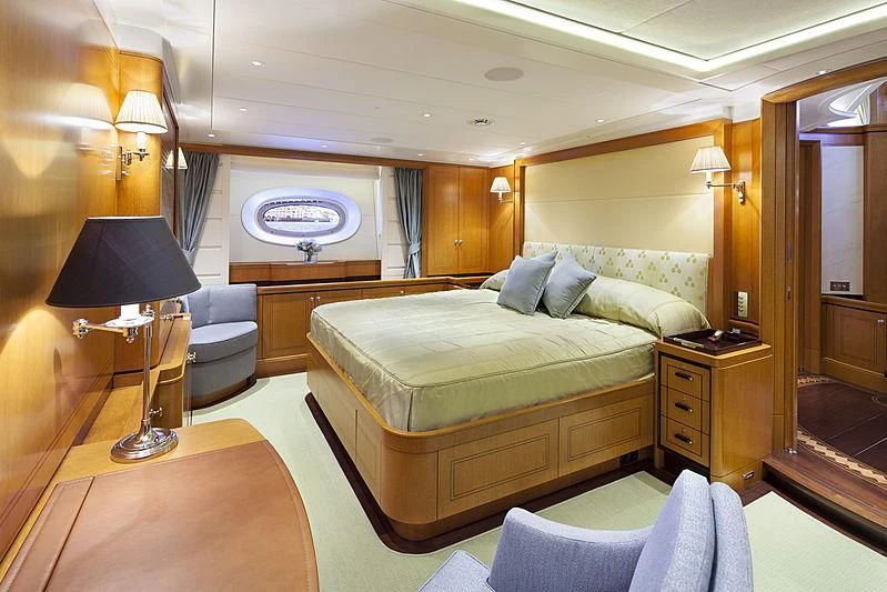 a bedroom with a bed and a lamp aboard WISP Yacht for Sale
