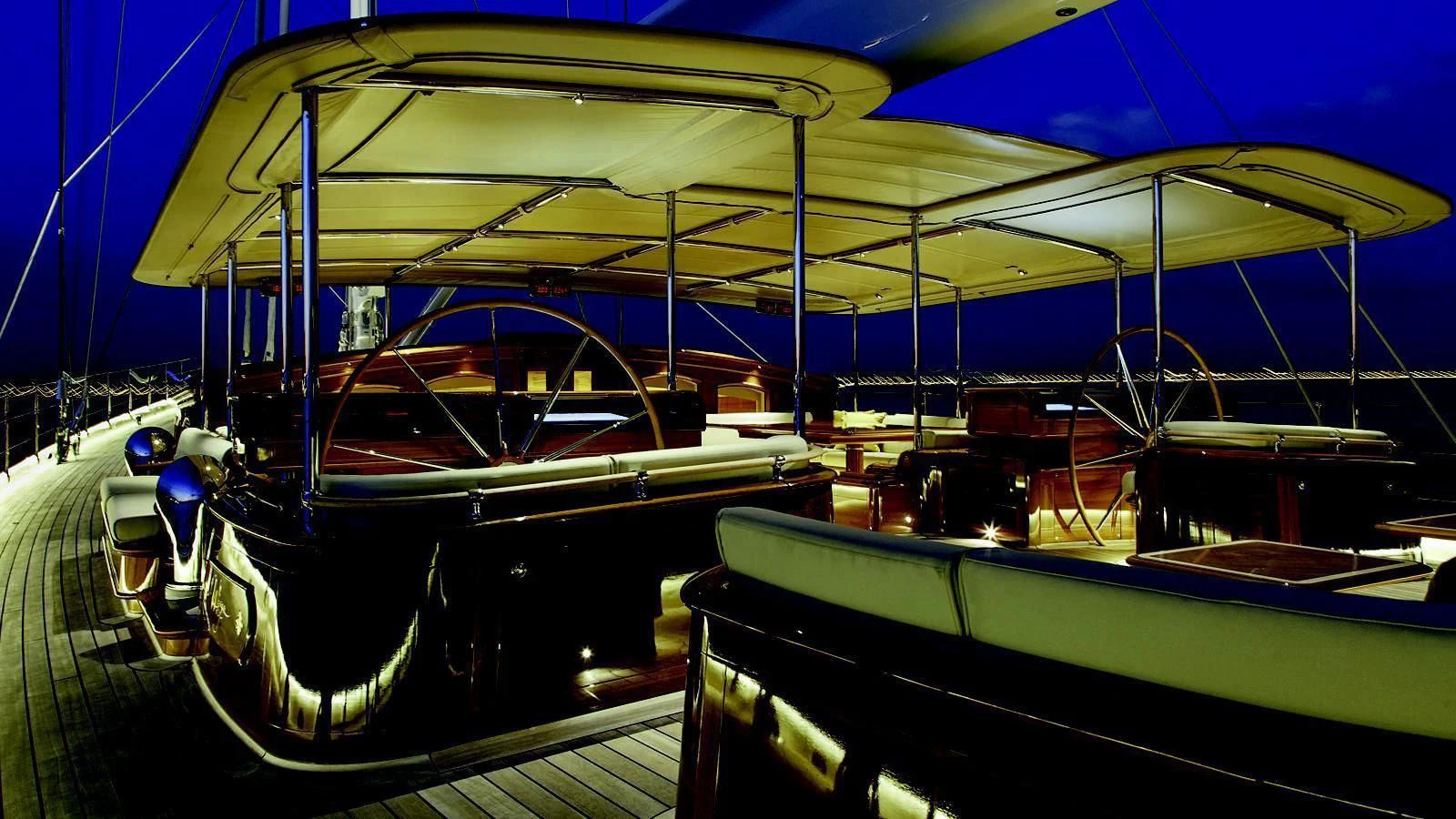 a large blue boat with a black boat in it aboard WISP Yacht for Sale