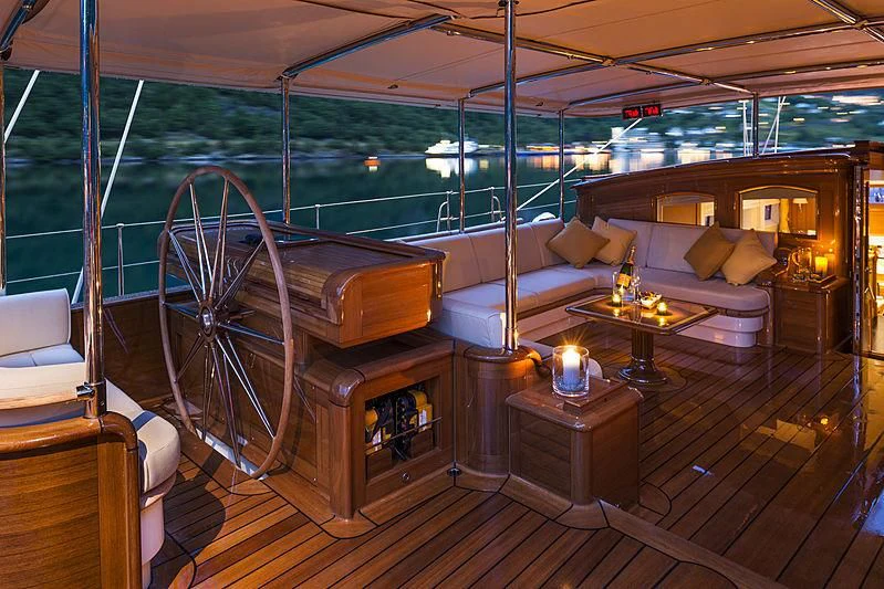 a boat with a bed and a table aboard WISP Yacht for Sale
