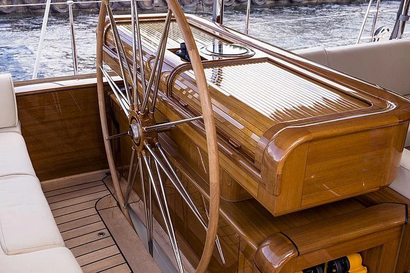 a wooden boat on a deck aboard WISP Yacht for Sale