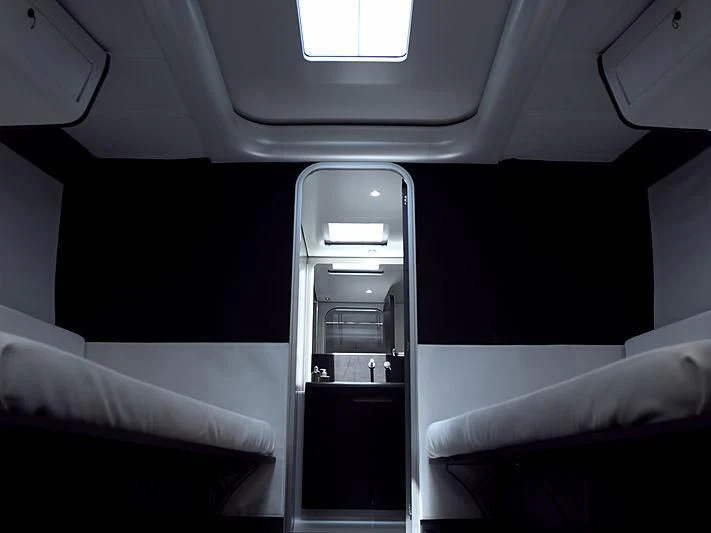 a room with a bed and a chair aboard BULLITT Yacht for Sale
