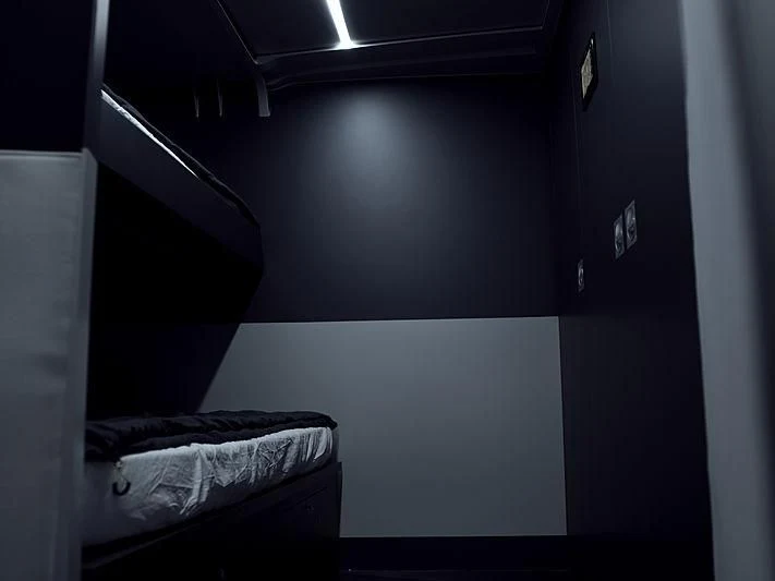 a black cabinet with a bed and a black ladder aboard BULLITT Yacht for Sale