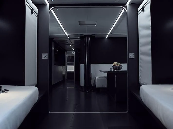 a dark room with a table and chairs aboard BULLITT Yacht for Sale