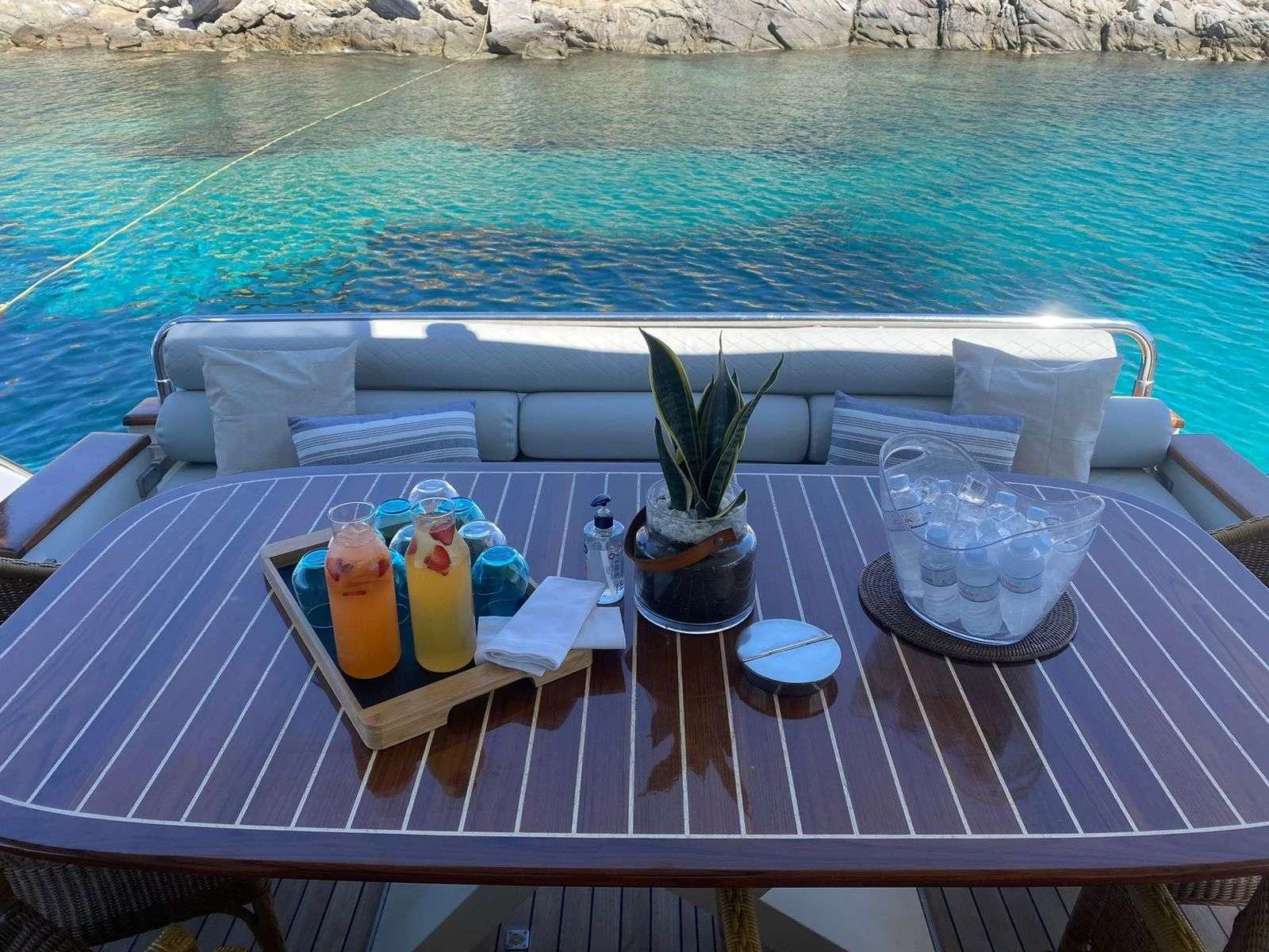 a table with drinks and a tray on it aboard ILLYA F Yacht for Charter