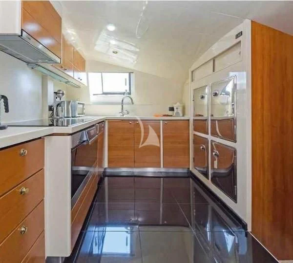 a kitchen with wooden cabinets aboard ILLYA F Yacht for Charter