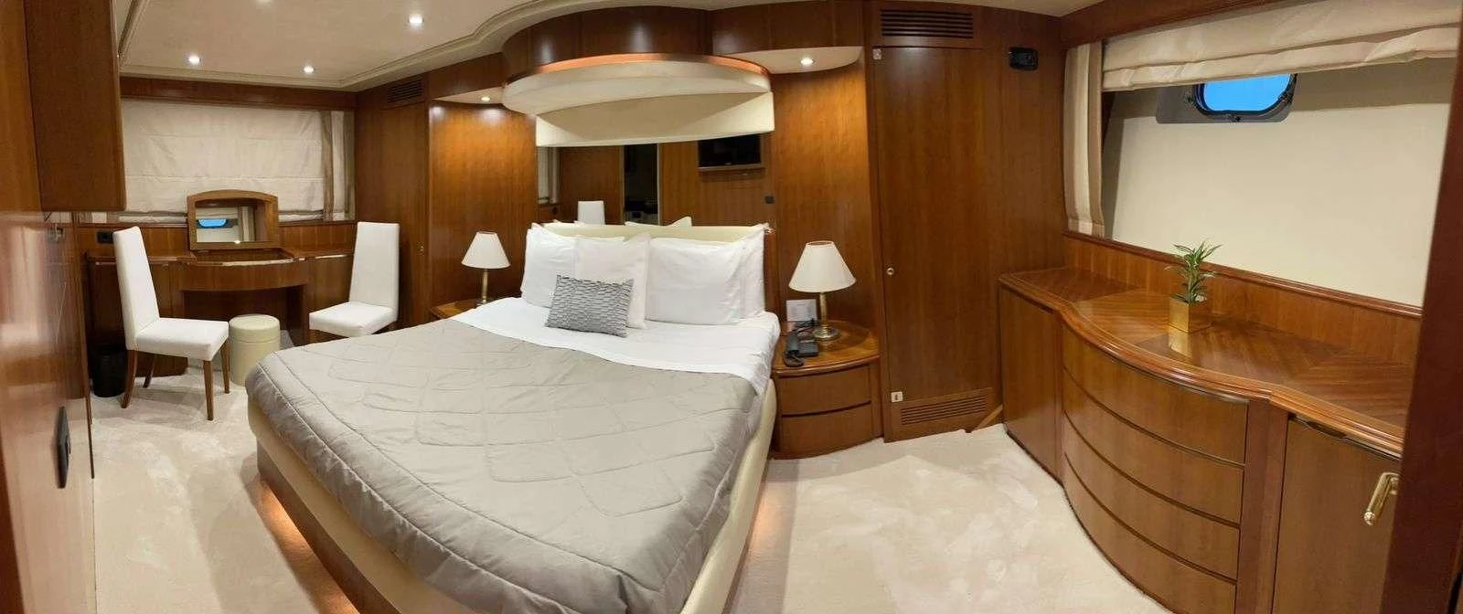 a room with a bed and desk aboard ILLYA F Yacht for Charter