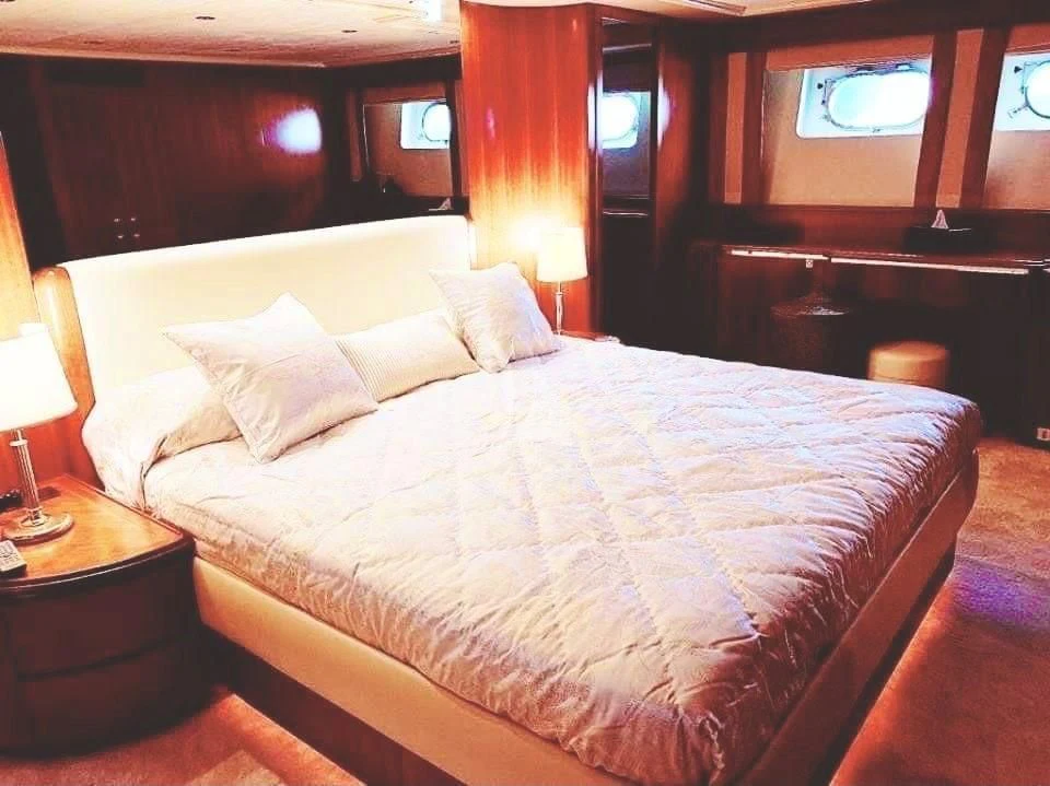 a bed with white sheets aboard ILLYA F Yacht for Charter
