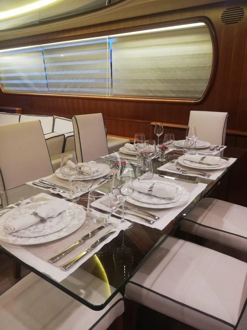 a table set with plates and glasses aboard ILLYA F Yacht for Charter