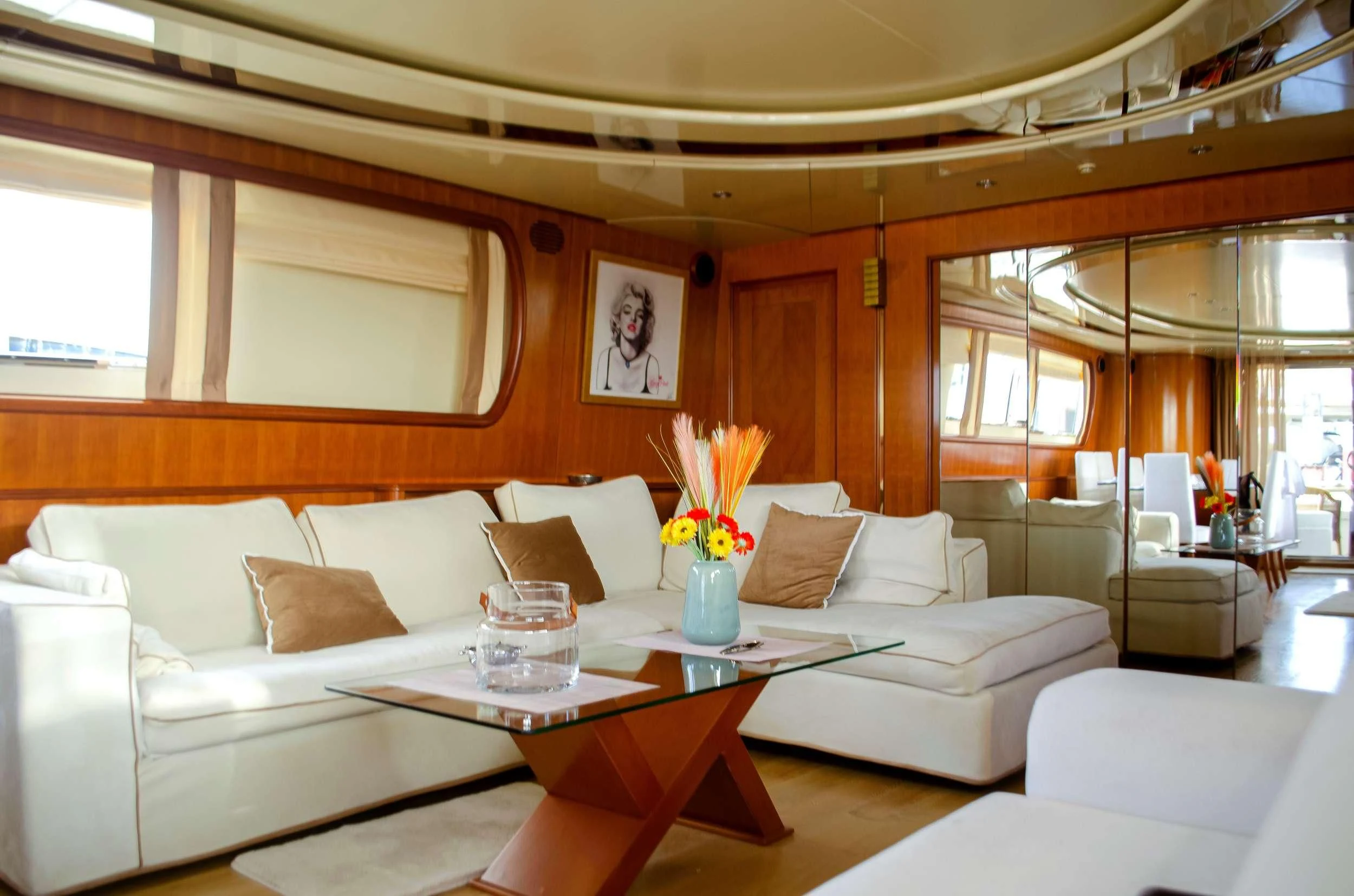a living room with a white couch and a table with flowers aboard ILLYA F Yacht for Charter