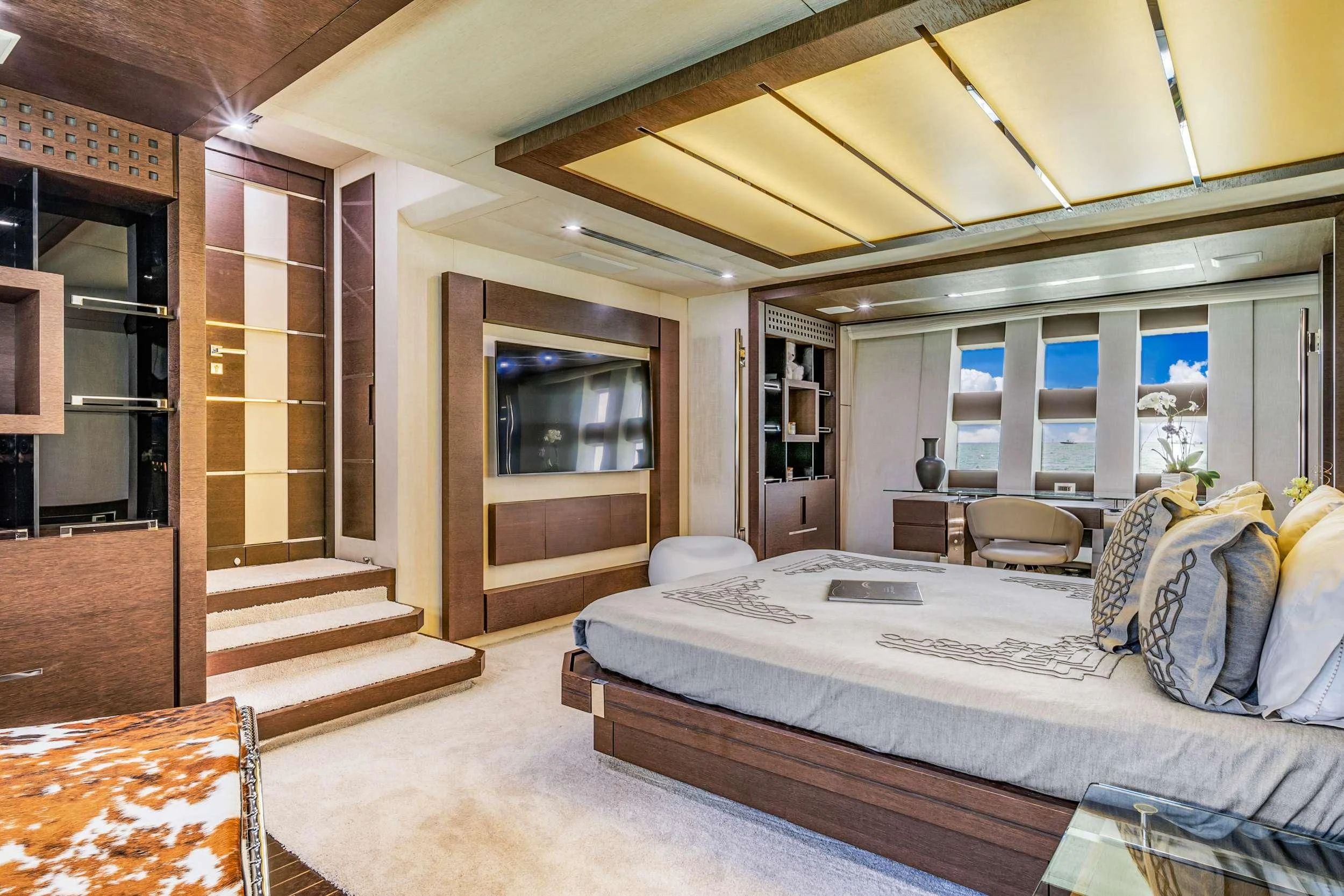 a bedroom with a bed and a table aboard SETTE Yacht for Sale