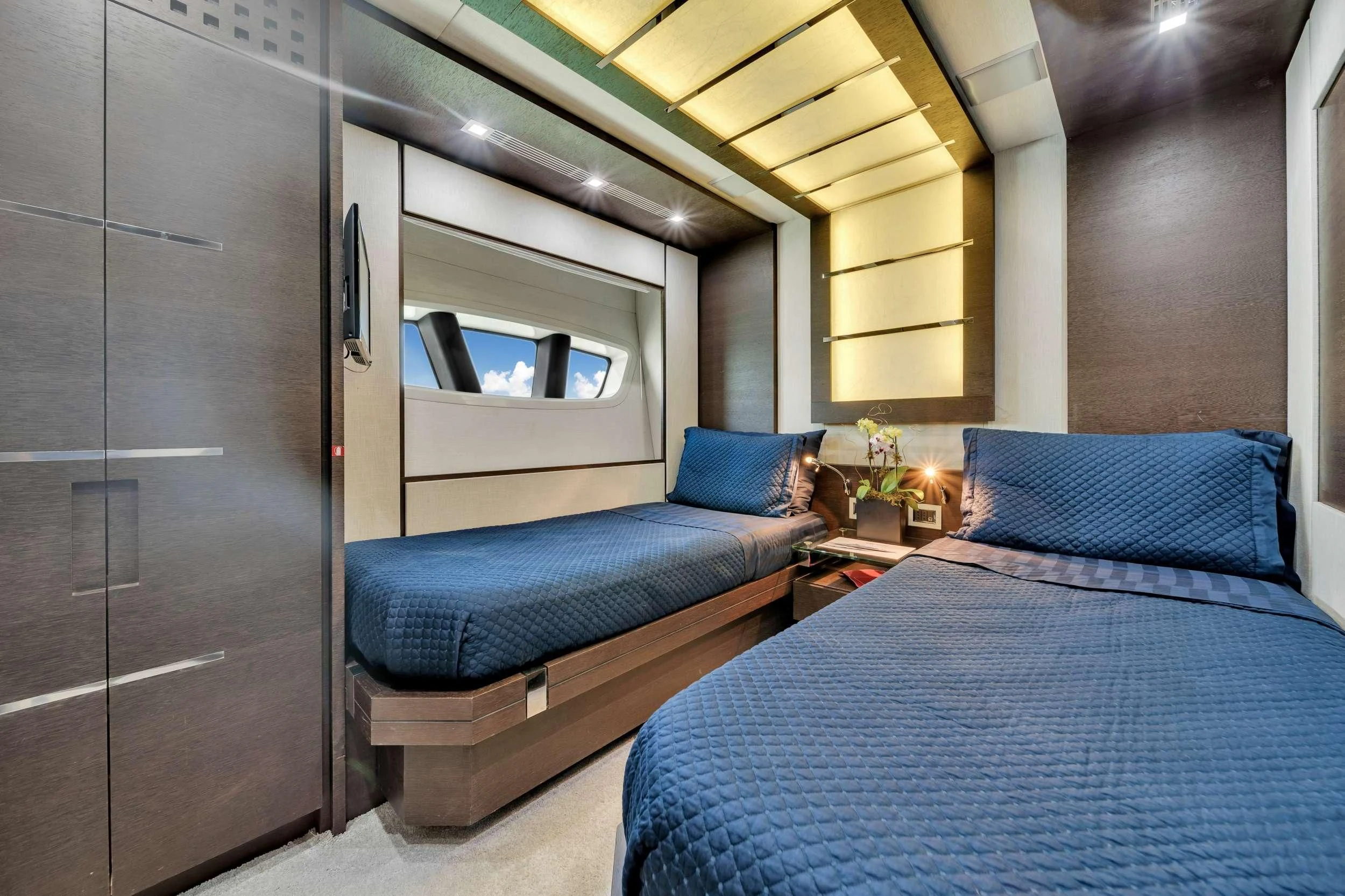 a bedroom with a bed and a blue bed aboard SETTE Yacht for Sale