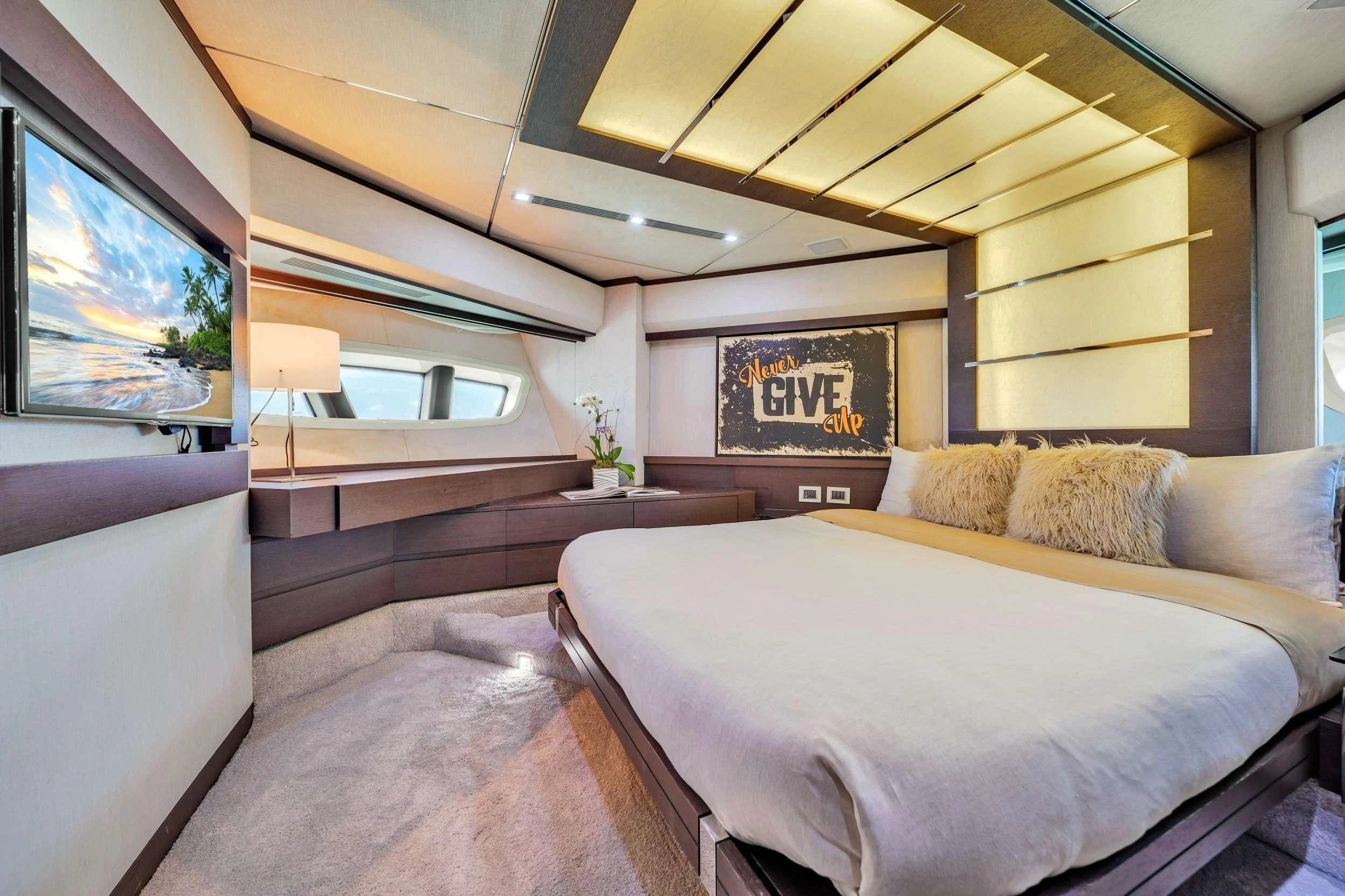 a bedroom with a bed and a tv aboard SETTE Yacht for Sale
