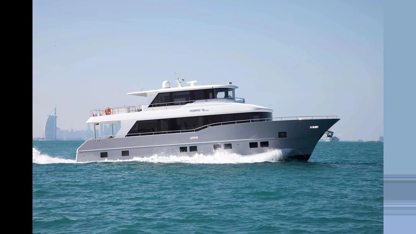 a large white boat on the water aboard NOMAD 70 SUV Yacht for Sale
