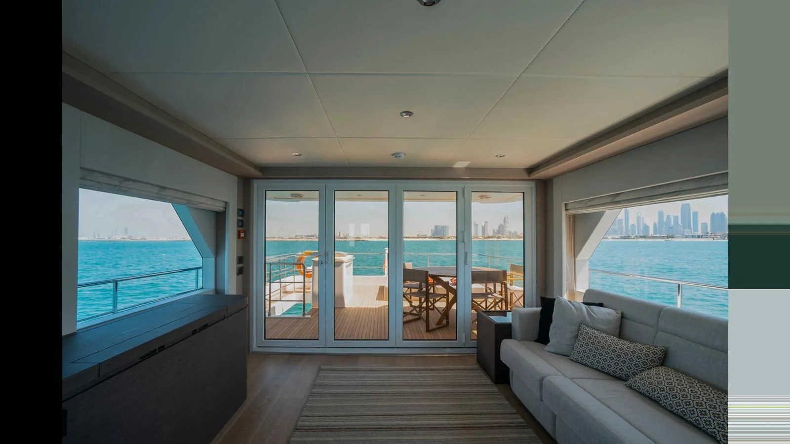 a living room with a large window aboard NOMAD 70 SUV Yacht for Sale