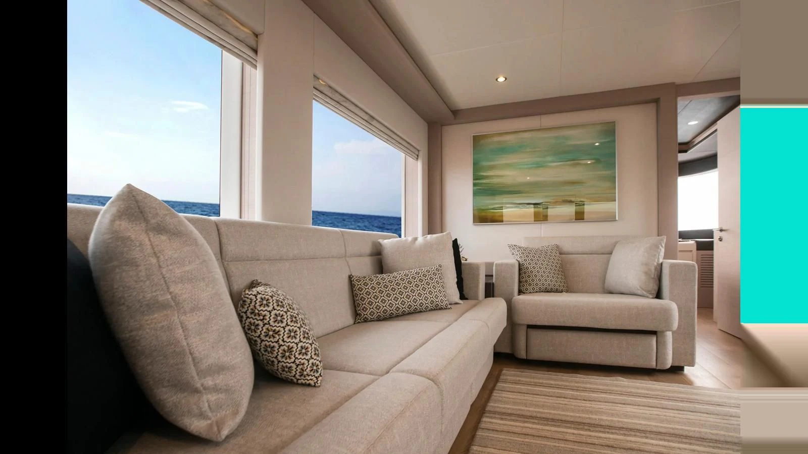 a living room with a couch and a window aboard NOMAD 70 SUV Yacht for Sale