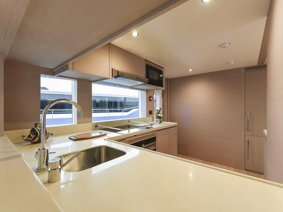 a kitchen with a sink and a microwave aboard NOMAD 70 SUV Yacht for Sale
