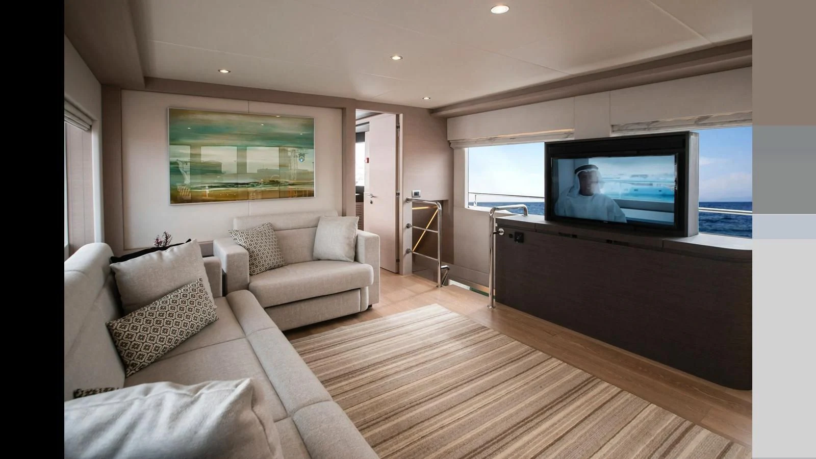 a living room with a large television aboard NOMAD 70 SUV Yacht for Sale