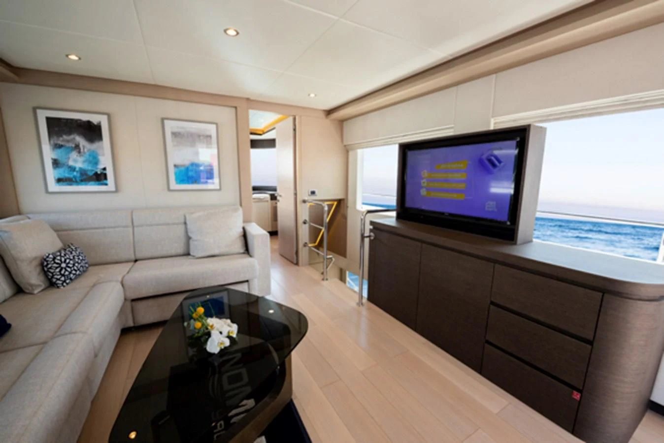 a living room with a large television aboard NOMAD 70 SUV Yacht for Sale