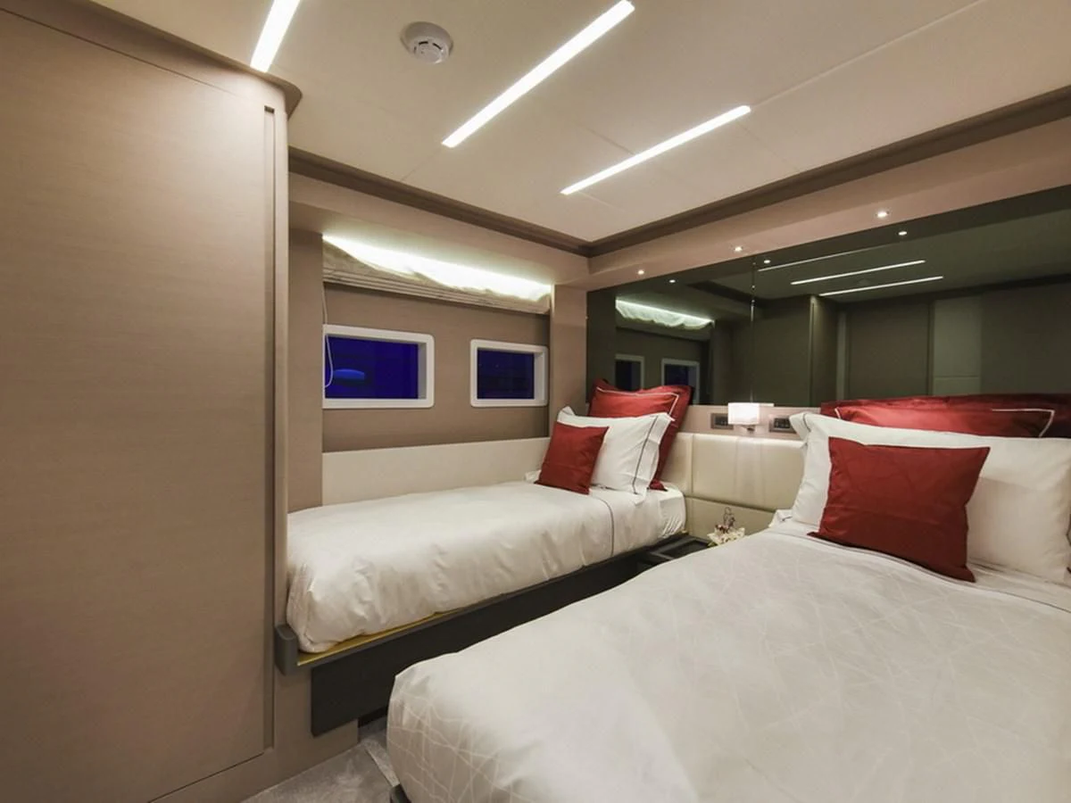 a room with two beds aboard NOMAD 70 SUV Yacht for Sale