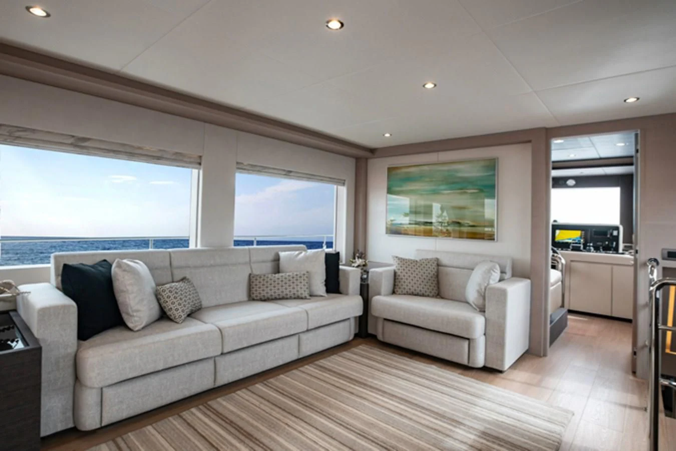a living room with a large window aboard NOMAD 70 SUV Yacht for Sale
