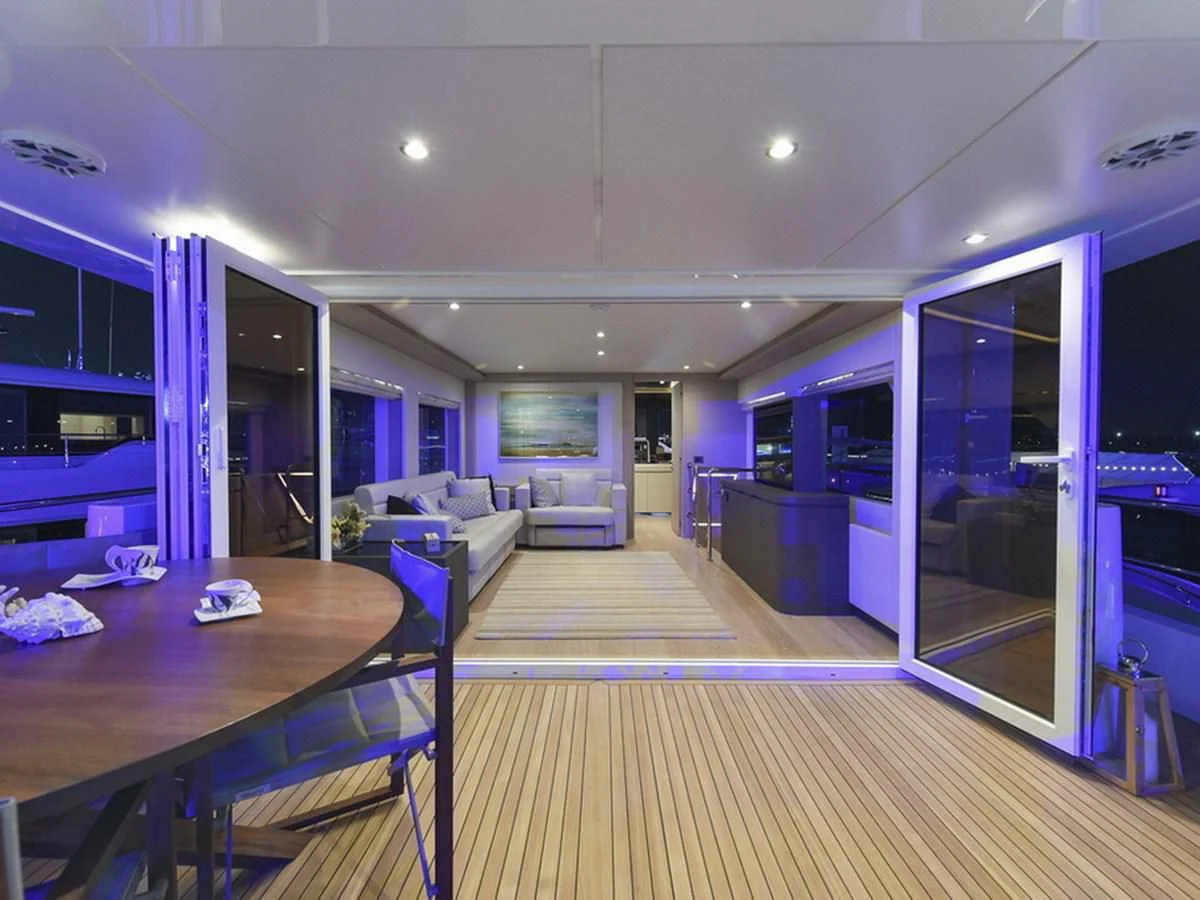 a room with a table and chairs aboard NOMAD 70 SUV Yacht for Sale