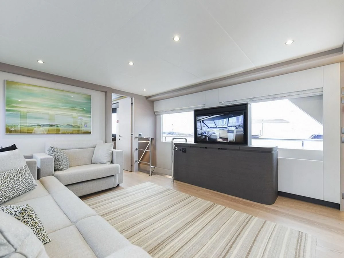 a living room with a large tv aboard NOMAD 70 SUV Yacht for Sale